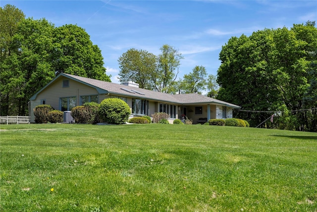 ranch-style house featuring a chimney and central AC unit