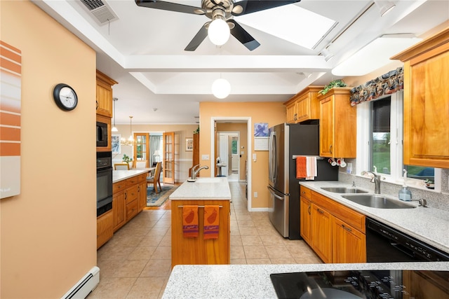 kitchen featuring light countertops, black appliances, a sink, a ceiling fan, and light tile patterned floors