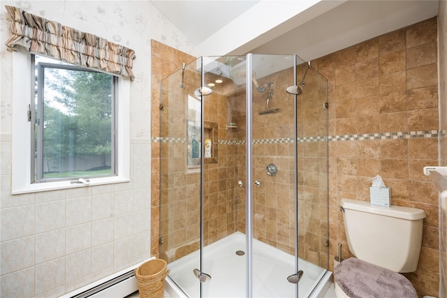 bathroom featuring a stall shower, a baseboard heating unit, toilet, and tile walls