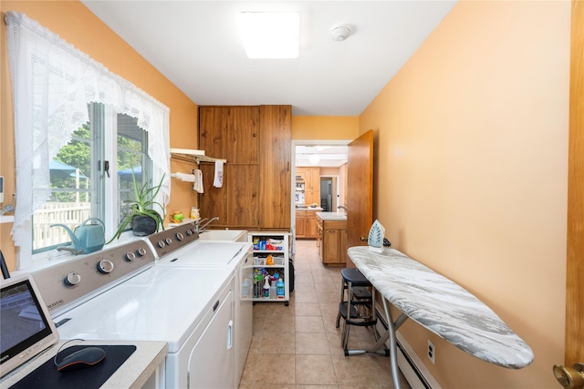washroom featuring washer and clothes dryer and light tile patterned floors