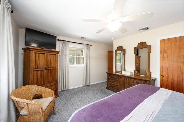 bedroom featuring carpet, multiple windows, baseboards, and ceiling fan