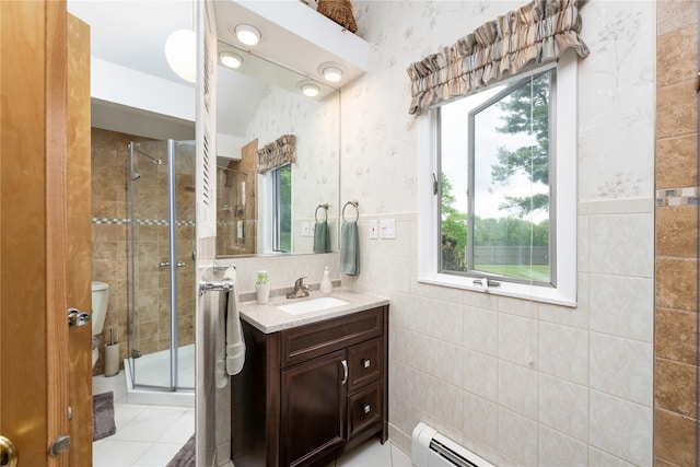 full bath with a shower stall, vanity, and tile walls