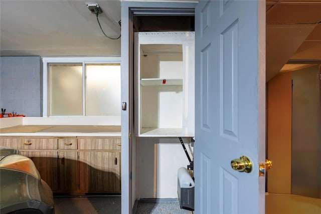bathroom featuring concrete block wall