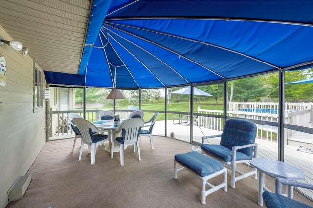 view of patio / terrace with a wooden deck and outdoor dining area