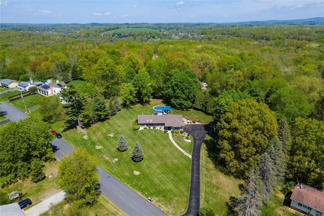 aerial view of property's location featuring a forest
