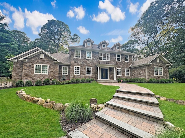 33 Bacon Rd, Saint James, NY 11780 - georgian-style home featuring stone siding and a front yard