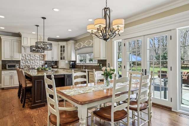 33 Bacon Rd, Saint James, NY 11780 - dining space featuring ornamental molding, a chandelier, wood finished floors, recessed lighting, and french doors