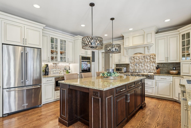 33 Bacon Rd, Saint James, NY 11780 - kitchen featuring stainless steel appliances, dark brown cabinets, a chandelier, light wood finished floors, and backsplash