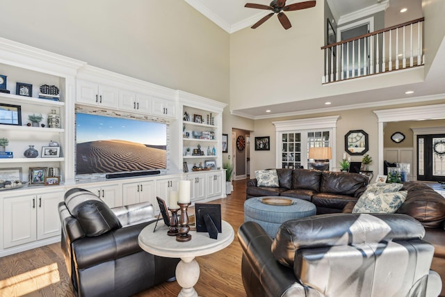 33 Bacon Rd, Saint James, NY 11780 - living room with a ceiling fan, light wood-style floors, crown molding, a high ceiling, and built in shelves