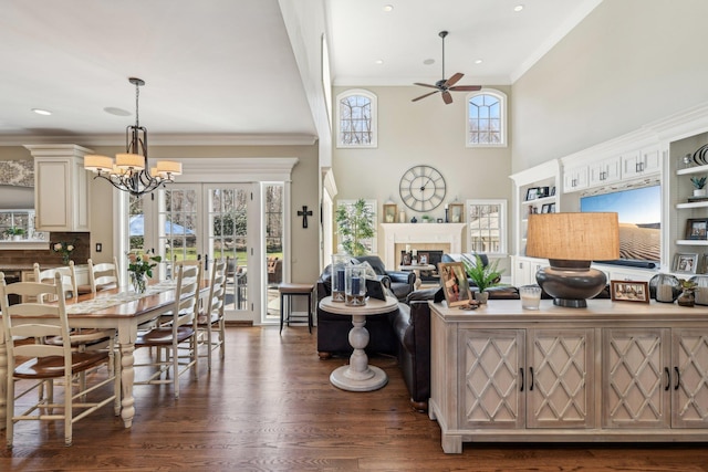 33 Bacon Rd, Saint James, NY 11780 - living area featuring ceiling fan, a chandelier, dark wood-style flooring, a tile fireplace, and ornamental molding