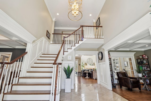 33 Bacon Rd, Saint James, NY 11780 - stairs with a decorative wall, ornamental molding, a chandelier, recessed lighting, and wainscoting