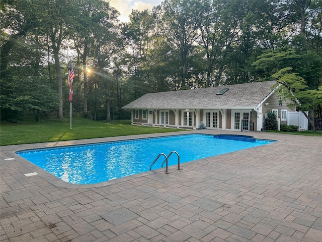 33 Bacon Rd, Saint James, NY 11780 - swimming pool featuring french doors, a yard, a patio, and view of wooded area