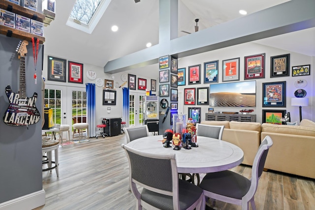 33 Bacon Rd, Saint James, NY 11780 - dining space featuring french doors, a skylight, high vaulted ceiling, wood finished floors, and recessed lighting
