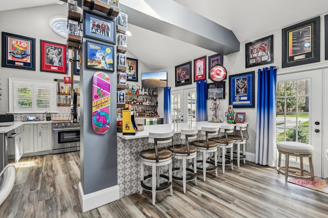 33 Bacon Rd, Saint James, NY 11780 - indoor wet bar featuring lofted ceiling, stainless steel appliances, and wood finished floors