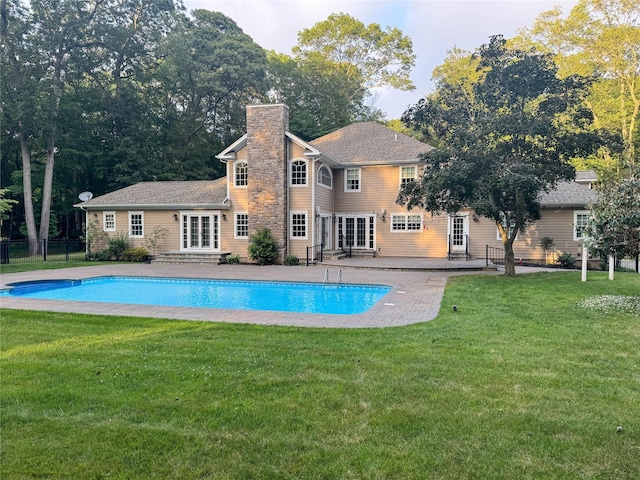 33 Bacon Rd, Saint James, NY 11780 - back of property with french doors, a chimney, a patio, and an outdoor pool