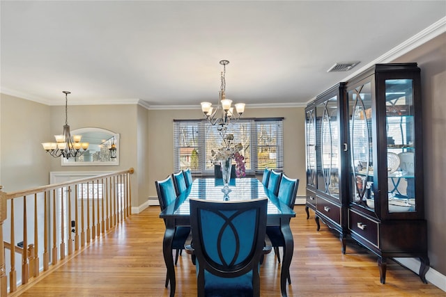 3 Bell Ct, Airmont, NY 10901 - dining space featuring ornamental molding, visible vents, light wood-type flooring, and an inviting chandelier