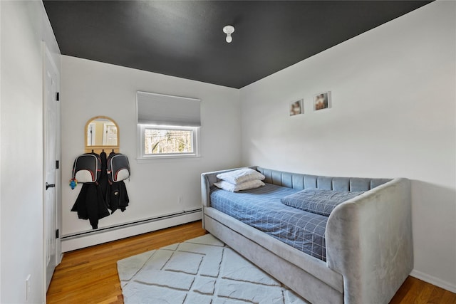 3 Bell Ct, Airmont, NY 10901 - bedroom featuring a baseboard heating unit and wood finished floors