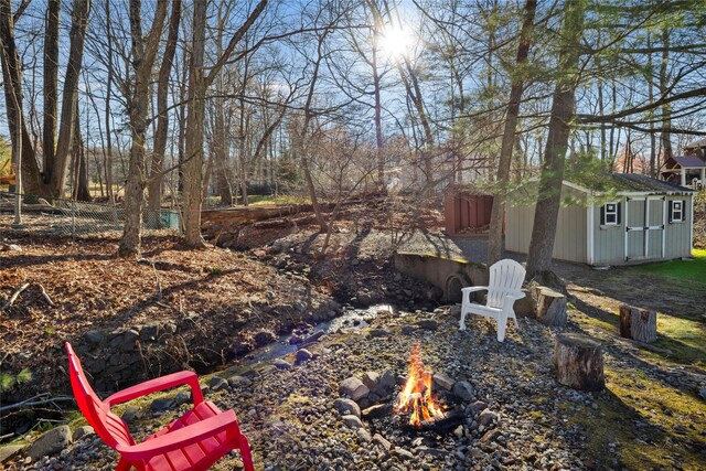 3 Bell Ct, Airmont, NY 10901 - view of yard with an outbuilding, an outdoor fire pit, fence, and a storage unit
