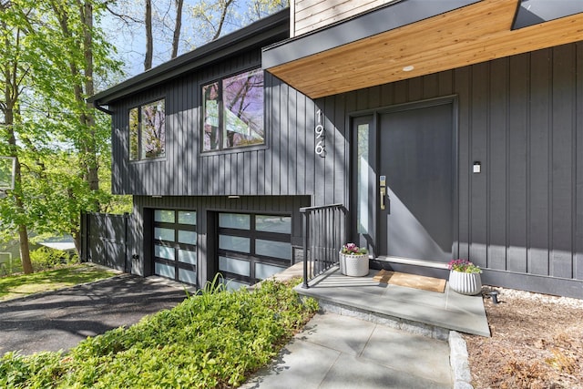 property entrance with a garage and driveway