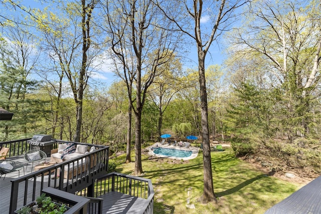 view of yard with a wooden deck and an outdoor pool