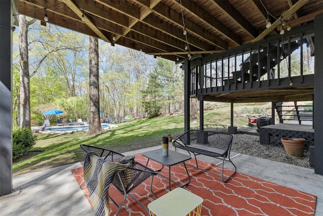 view of patio with an outdoor pool and stairway