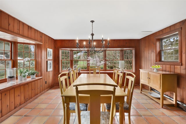 29 Oscaleta Rd, South Salem, NY 10590 - dining area featuring wood walls, a notable chandelier, light tile patterned flooring, and baseboards