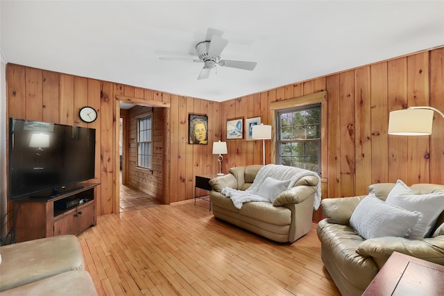 29 Oscaleta Rd, South Salem, NY 10590 - living area with wood walls, a ceiling fan, and light wood finished floors
