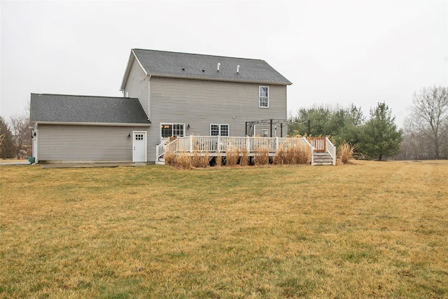 back of house with a lawn and a deck