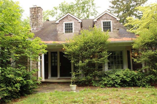7 Locust Ln, Glen Head, NY 11545 - cape cod-style house featuring a chimney, roof with shingles, and a porch