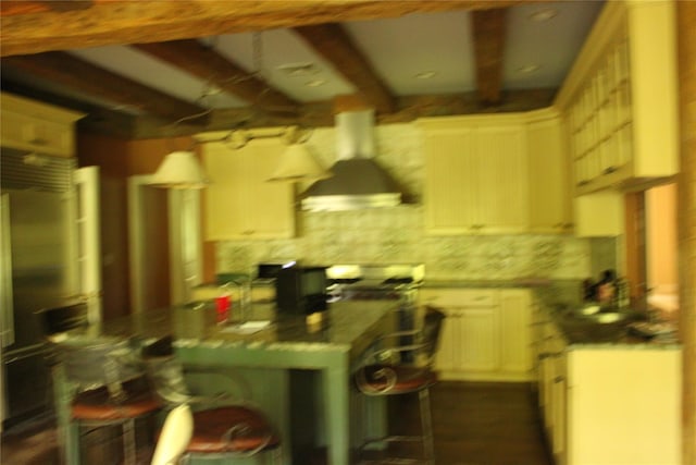 7 Locust Ln, Glen Head, NY 11545 - kitchen with exhaust hood, a kitchen bar, beamed ceiling, white cabinetry, and decorative backsplash
