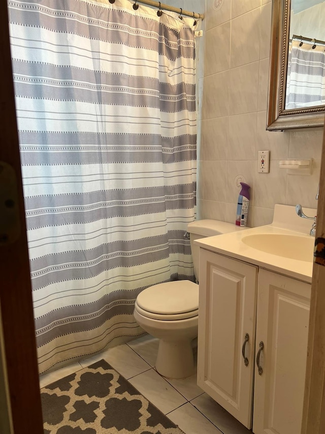 bathroom featuring vanity, curtained shower, tile walls, toilet, and tile patterned flooring