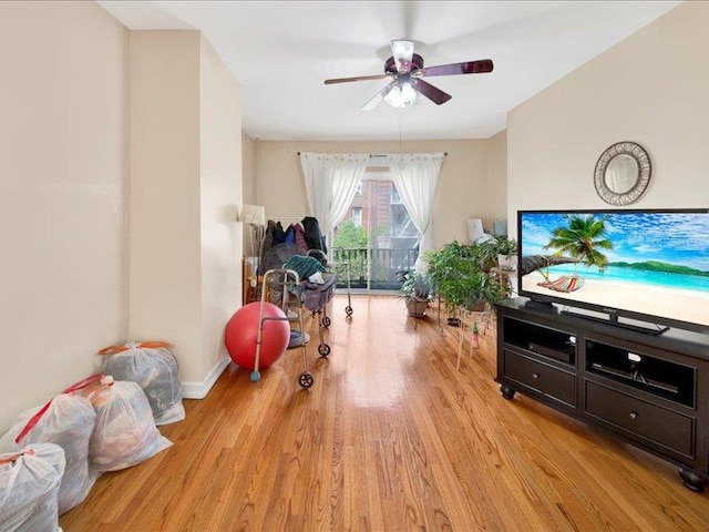 playroom featuring light wood-type flooring, baseboards, and ceiling fan