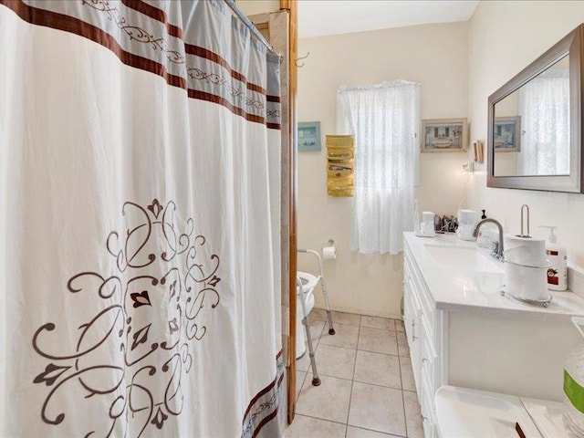 bathroom featuring tile patterned flooring, a shower with shower curtain, and vanity