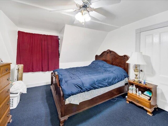carpeted bedroom with ceiling fan and lofted ceiling