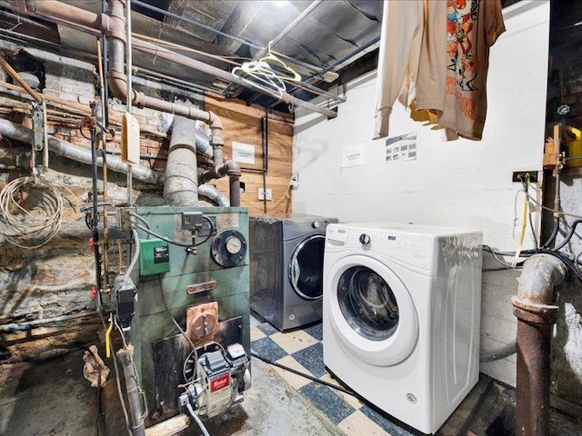 2790 Bainbridge Ave, Bronx, NY 10458 - laundry area with laundry area, washer and clothes dryer, tile patterned floors, and concrete block wall