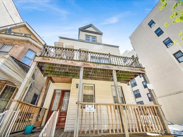 2790 Bainbridge Ave, Bronx, NY 10458 - view of front of home with a wooden deck and covered porch