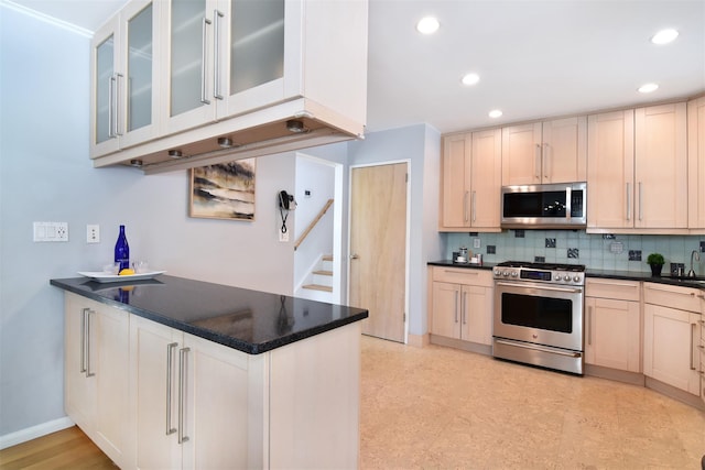 435 Carol Pl, Pelham, NY 10803 - kitchen with dark countertops, tasteful backsplash, appliances with stainless steel finishes, and a sink