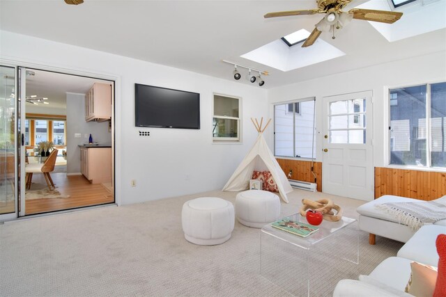 435 Carol Pl, Pelham, NY 10803 - interior space featuring baseboard heating, carpet floors, a ceiling fan, and a skylight