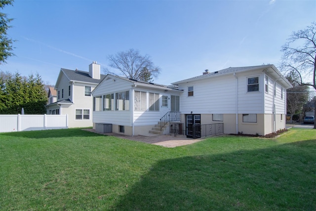 435 Carol Pl, Pelham, NY 10803 - rear view of property featuring a yard, fence, and a sunroom