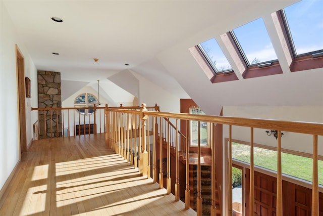 hallway with light wood-style flooring and a healthy amount of sunlight