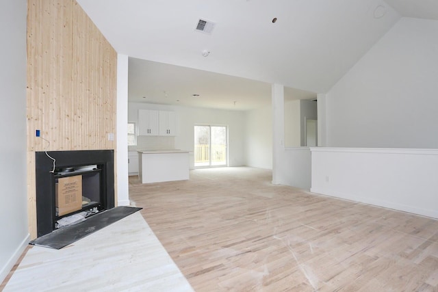 334NOhioville Rd, New Paltz, NY 12561 - unfurnished living room featuring lofted ceiling, light wood-style flooring, and visible vents