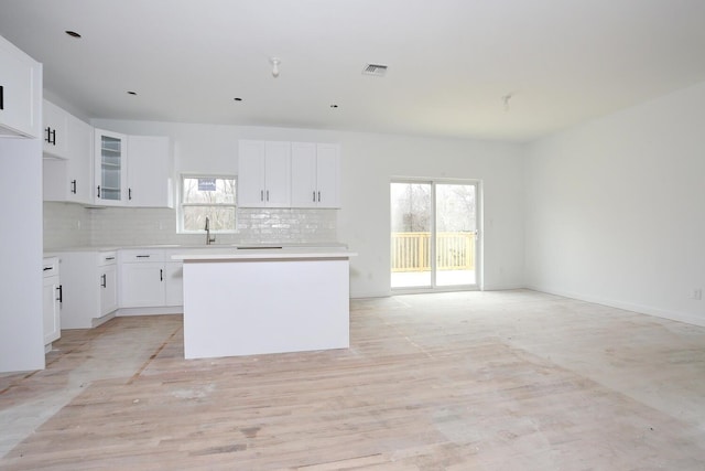 334NOhioville Rd, New Paltz, NY 12561 - kitchen with visible vents, a center island, a wealth of natural light, and decorative backsplash