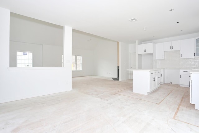 334NOhioville Rd, New Paltz, NY 12561 - kitchen with white cabinets, open floor plan, visible vents, and decorative backsplash