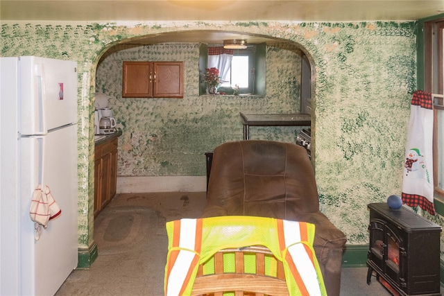 carpeted dining space with wallpapered walls