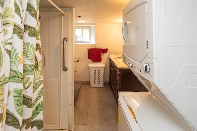 bathroom featuring stacked washer and dryer, a shower with shower curtain, and vanity