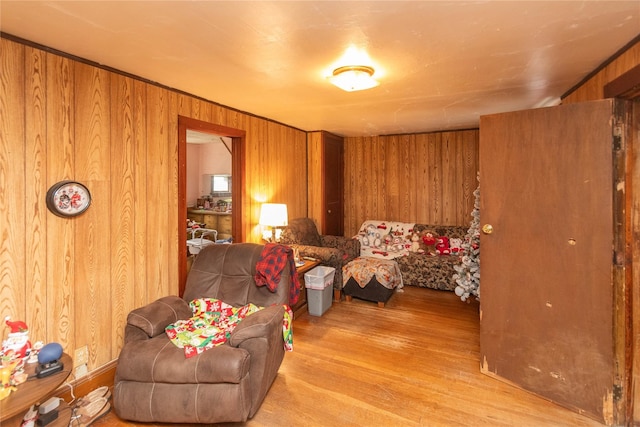 bedroom with wooden walls and light wood-type flooring