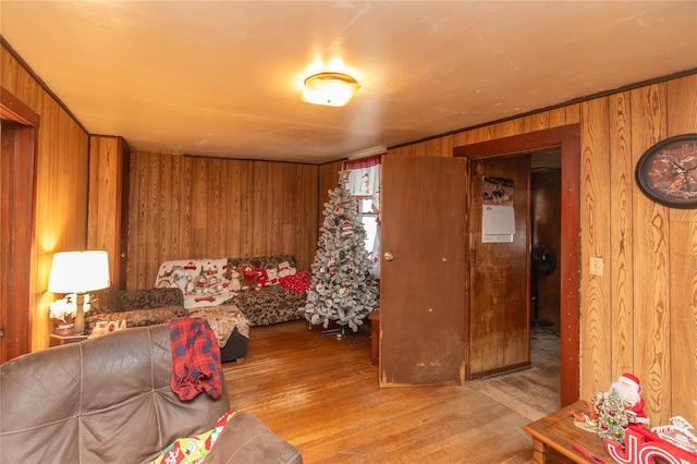 living area with wood walls and light wood finished floors