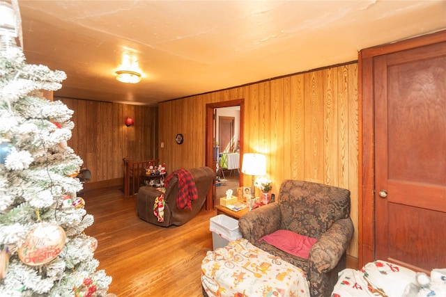 living room featuring wood finished floors and wooden walls