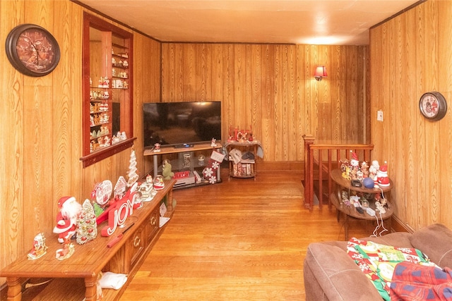 living area with wood finished floors and wood walls