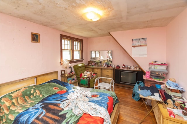 bedroom with wood finished floors